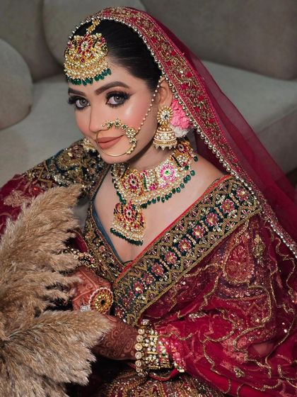 A close-up of the bride's look, focusing on the detailed embroidery of the blouse and the beautiful bridal jewelry that complements the outfit.