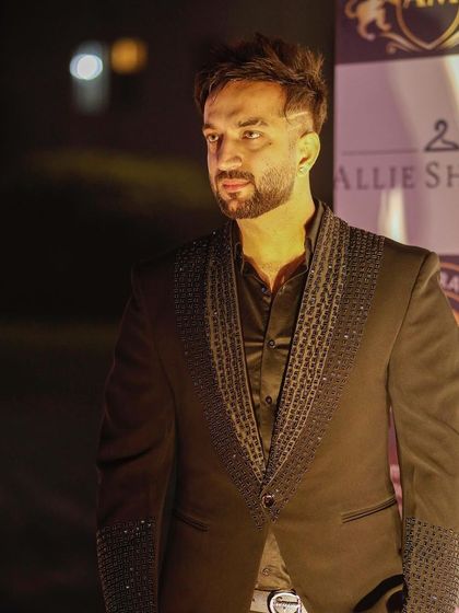 A client at an evening event in our black tuxedo with a beaded lapel. The subtle shimmer makes it perfect for a sophisticated party look.