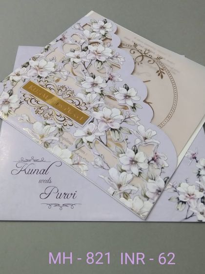 A beautiful invitation with a unique scalloped edge, decorated with a print of white magnolia flowers. The design is elegant and distinctive, perfect for a memorable announcement.