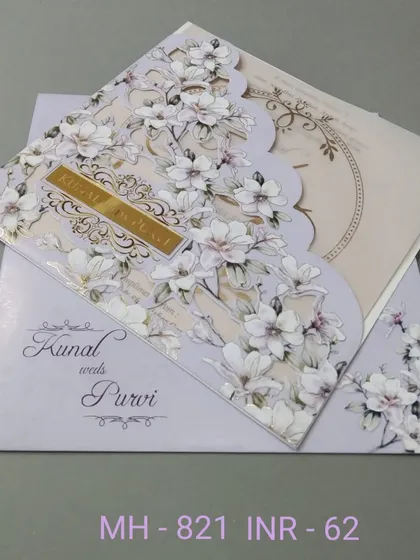 A beautiful invitation with a unique scalloped edge, decorated with a print of white magnolia flowers. The design is elegant and distinctive, perfect for a memorable announcement.