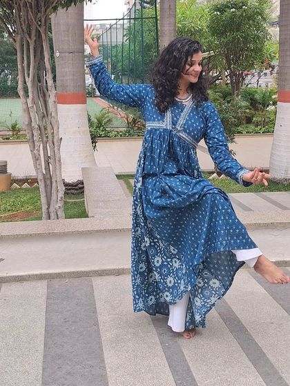 A side profile of a dance pose, showing the elegant lines of semi-classical movement.