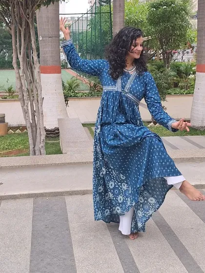 A side profile of a dance pose, showing the elegant lines of semi-classical movement.