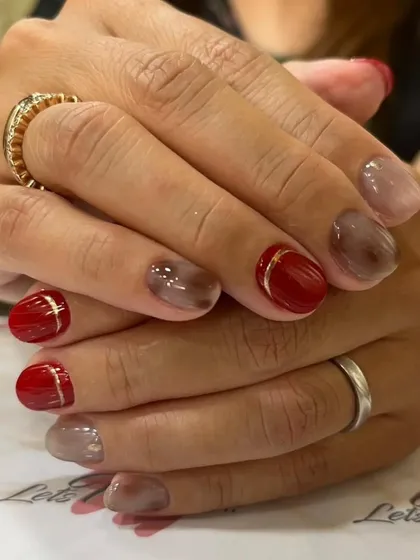 A side view of the red and smoke manicure, showing the depth of the design.