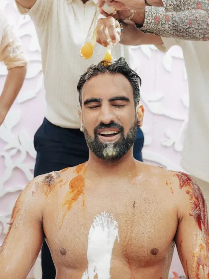 A portrait of the groom during his haldi, a moment of pure surrender to the joyful chaos of the ritual.