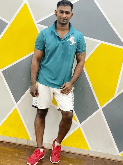 A casual pose against the vibrant wall of our studio. The bright colors reflect the energy we bring to every class.