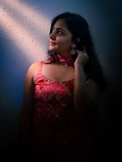I enjoy playing with light and shadow to create artistic and moody portraits. This shot from a Mehendi shoot uses a sliver of light to highlight the bride's thoughtful expression, adding a touch of drama.