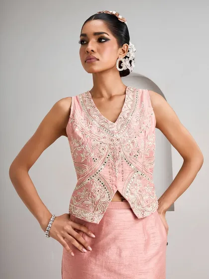 The front view of this pink embroidered vest showcases its intricate embellishments and modern cut. It's a versatile piece that can be styled in multiple ways for different festive occasions.