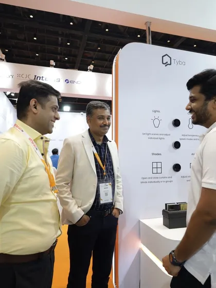 Three professionals networking at a booth, demonstrating the constant flow of business and partnership opportunities available on the expo floor.