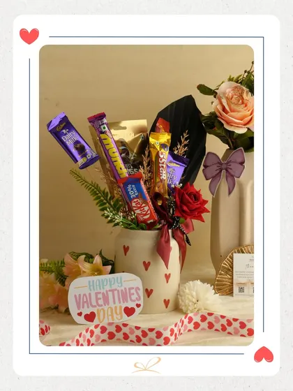 A different take on the chocolate bouquet, this one combines various chocolates like Dairy Milk and KitKat with a single red rose in a heart-printed mug. It's a sweet and personal gesture.