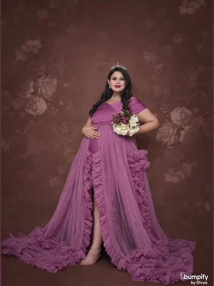 A beautiful solo shot with a floral-patterned backdrop that complements the purple gown. The addition of a bouquet adds a soft, romantic touch.