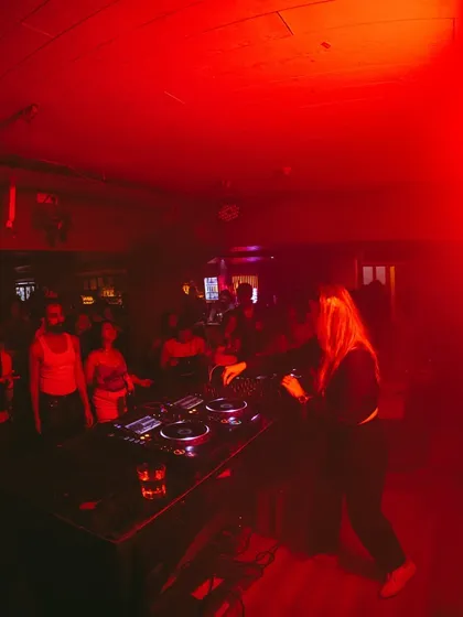 A fish-eye lens captures the entire scene, with the red lights washing over the crowd and me at the center.