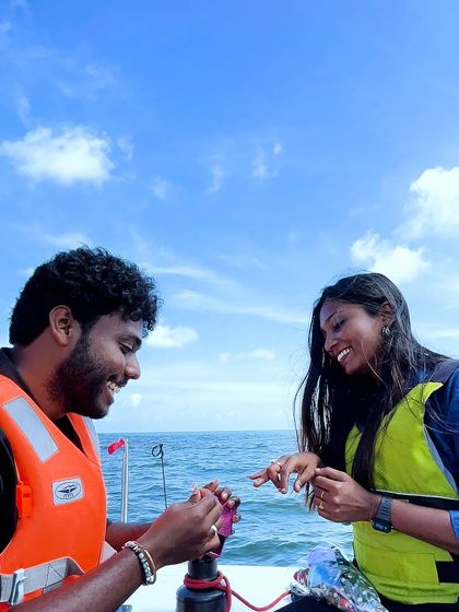 She said yes! The happy moment of putting on the engagement ring during a surprise yacht proposal.