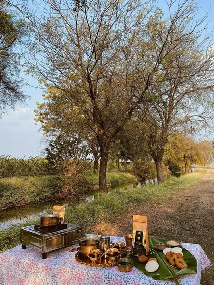 We set up this shot on location at an organic farm to capture the brand's rustic, farm-to-table essence. The outdoor setting with traditional brass utensils creates an authentic and beautiful scene.