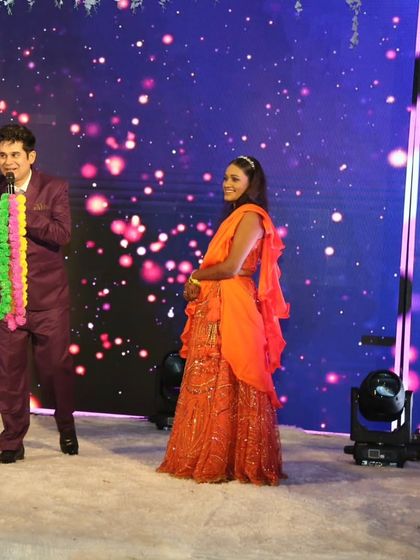 On stage during a sangeet, interacting with a family member. My goal is to make everyone feel like they are a part of the show, not just spectators.