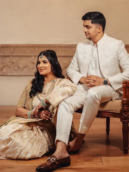 A picture of modern royalty. The couple looks poised and elegant, with the bride's soft makeup and traditional attire creating a beautiful contrast in this classic portrait.