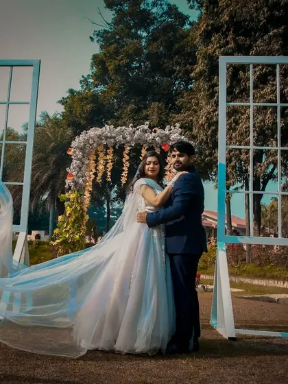 A pre-wedding shoot using creative props like these large window frames to create a unique and beautiful setting.