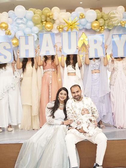 The proud new parents with baby Shaurya, posing with the family members who helped reveal his name. A beautiful family portrait to cherish forever.