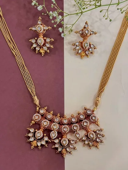Crafted to perfection, this gold necklace set with polki diamonds tells a tale of elegance and grace. I believe in wearing your heritage with pride, and this piece allows you to do just that.