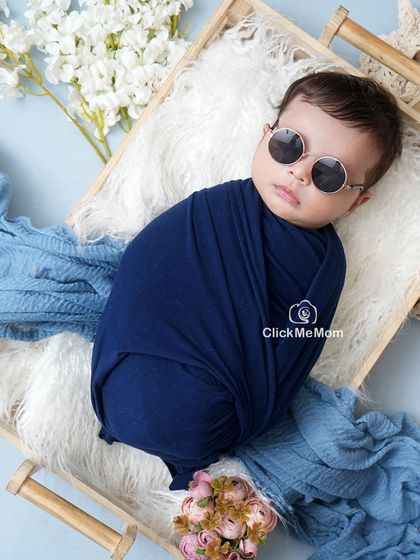 This little one is already a cool dude. Adding a simple prop like these round sunglasses can bring a touch of fun and personality to a classic swaddled shot.