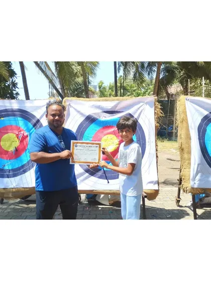 A young archer from our May 2023 summer camp receiving his certificate. He had a great time and learned a lot.
