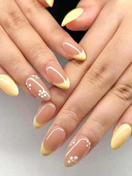 A soft yellow French manicure with delicate white dot-flower accents. This is a sweet and simple design, perfect for spring and summer.