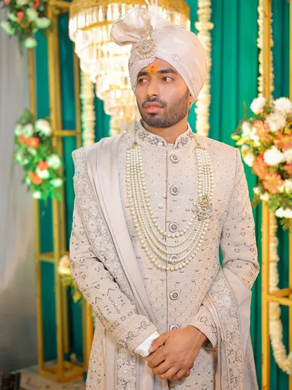 A portrait of the groom looking sharp in his off-white sherwani and traditional turban. I make sure the groom gets just as much attention, with classic portraits that highlight his attire and capture his personality on the wedding day.
