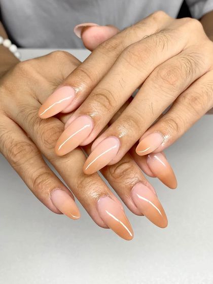 A beautiful nude ombre on long, stiletto-shaped extensions. The gradual fade is seamless and elegant.