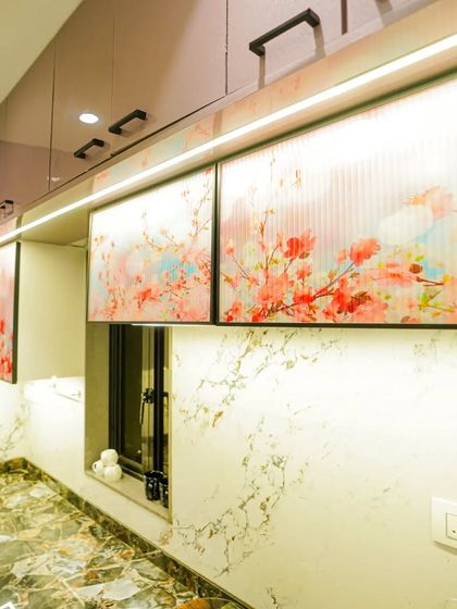 A closer look at the digital fluted glass shutters used in this kitchen. This unique material adds a touch of color and artistry, elevating the design of the overhead cabinets.