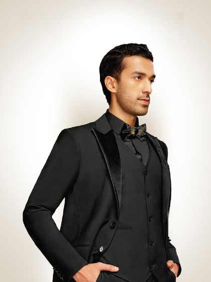 A well-fitted suit is a man’s best armor. This all-black tuxedo with a velvet lapel and a statement bow tie is designed to make you feel powerful and confident.