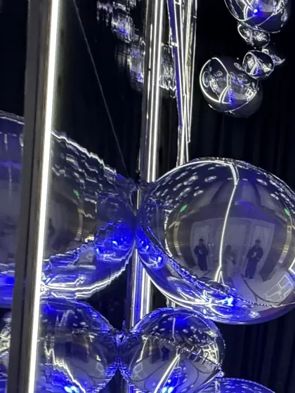 A world full of funk. A close-up of the silver bubble installation, where reflections and light create a mesmerizing and futuristic effect. 🪩