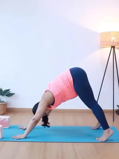 A modified downward-facing dog helps create space in the pelvis and is a safe way to stretch your back and hamstrings during the third trimester.