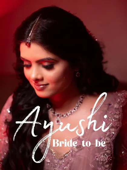 A beautiful close-up of the bride-to-be, Ayushi, capturing her flawless makeup and the serene expression of a woman in love.