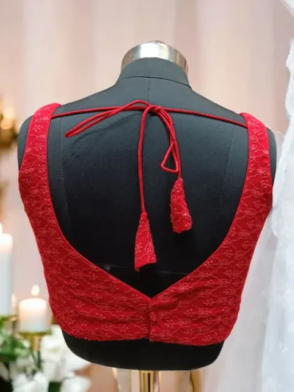 This beautiful red lace blouse is perfect for your party and wedding needs. The deep U-back with tassels adds a touch of traditional glamour.