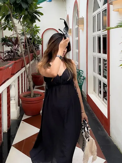 A playful moment taking off sunglasses, adding personality to the shoot.
