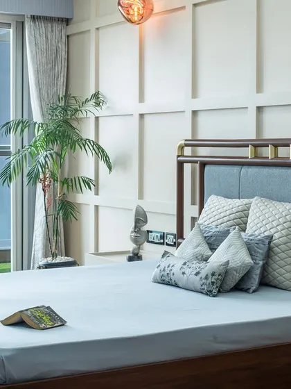 The view from the bed, looking out onto the balcony. Floor-to-ceiling glass doors flood the room with natural light, making it feel open and connected to the outdoors.