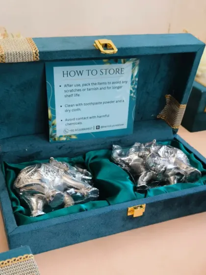 The interior of the suede box, featuring two German silver elephants nestled in rich green satin. I also included a "How to Store" card to add value and ensure the longevity of the gift.