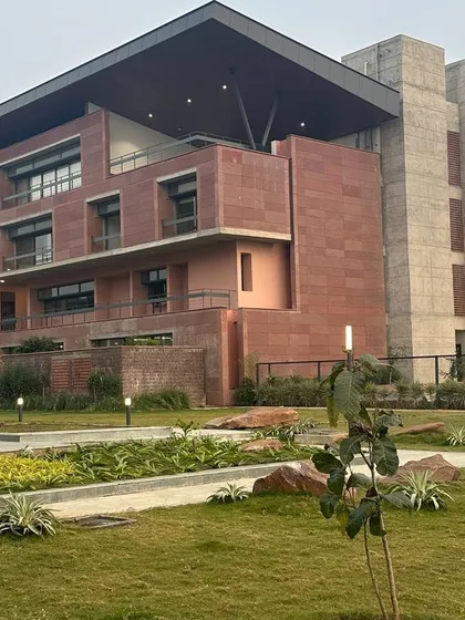 The fast-track building at Azim Premji University in Bhopal, clad in local Farsi sandstone. The design draws inspiration from the region's historical monuments, featuring climate-responsive elements like deep overhangs and north-south orientation to create a sustainable campus.