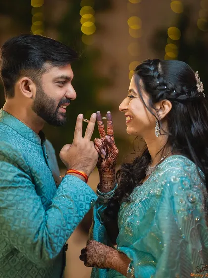 A fun and playful ring shot with Varad and Dr. Rutuja. These creative poses are a great way to add personality to your engagement album.