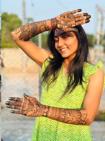 A candid shot of a happy bride enjoying her beautiful, dark-stained mehendi outdoors. I use only natural henna for the best color.