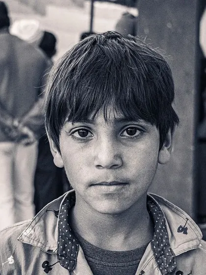 I often shoot in black and white to focus on emotion. The direct gaze of this child in Punjab is so powerful. Without the distraction of color, you can connect more deeply with the subject's expression.