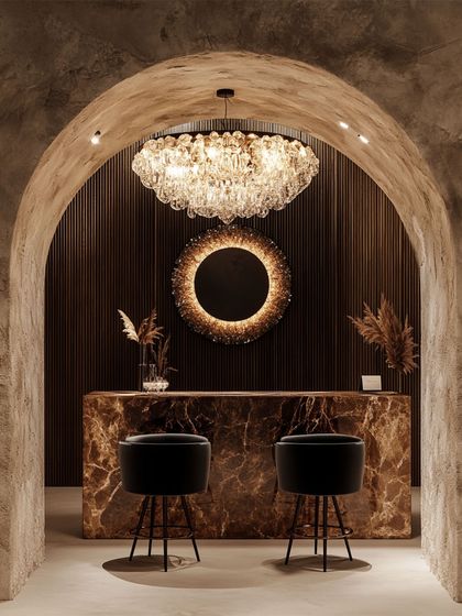 A classic tiered crystal chandelier brings timeless opulence to this space. Paired with a modern sunburst mirror, it demonstrates how I blend classic and contemporary elements to create a rich, sophisticated interior.