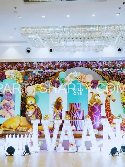 We create immersive jungle and safari adventures with lifelike 3D animal props and lush, layered backdrops. This 'Wild One' stage setup shows our ability to transform a venue into a vibrant wilderness, perfect for a little explorer's first birthday.