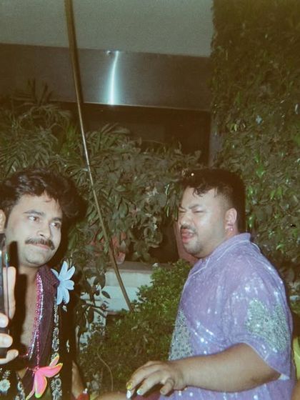 A film photo capturing a fun, unposed moment between friends at one of my events. This is the community vibe I strive to create.