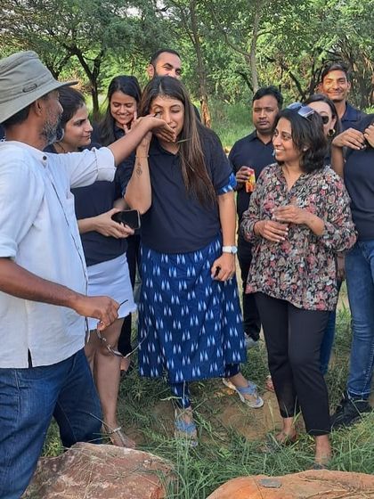 A fun, interactive moment as our expert lets Bacardi volunteers smell a native plant, connecting them to the sensory experience of the forest.