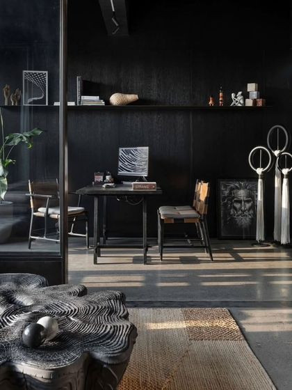 A detail of the principal architect's cabin, featuring a sculptural wooden coffee table and curated art pieces.