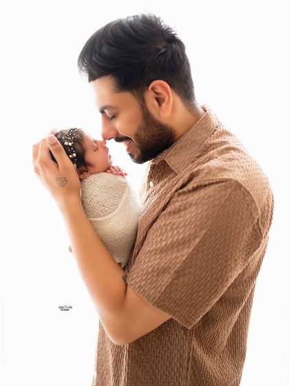A father's gentle touch. This close-up captures the sweet bond between a new dad and his baby.