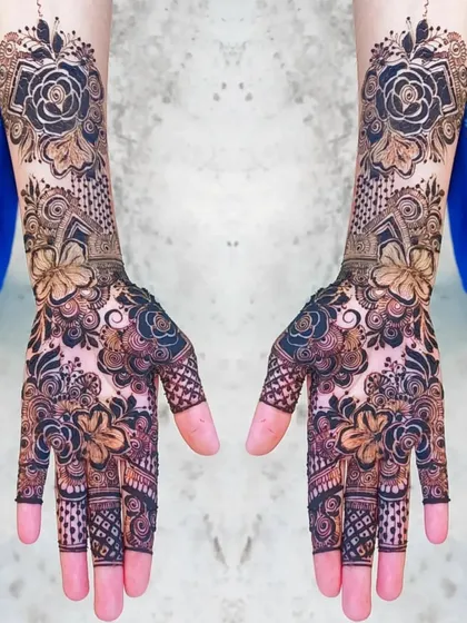 This design showcases a beautiful contrast between bold, dark floral patterns and lighter, intricate filler work. It's a modern take on the full coverage bridal look.