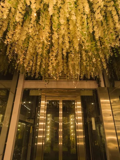 Every detail counts. Our decor team ensures your vision becomes a reality, like this stunning floral installation above the elevator.