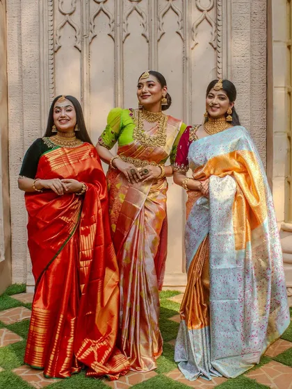 A group of models showcasing different ways to style our jewellery with various silk sarees for a festive or wedding occasion.