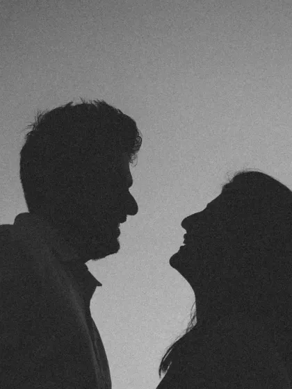 A close-up silhouette that is both intimate and powerful. Black and white photography excels at highlighting shapes and emotions, making this a truly striking portrait.